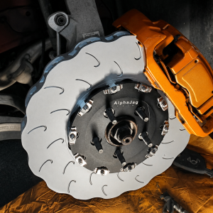 Jaguar lightweight two-piece performance brake rotor installed with factory performance caliper